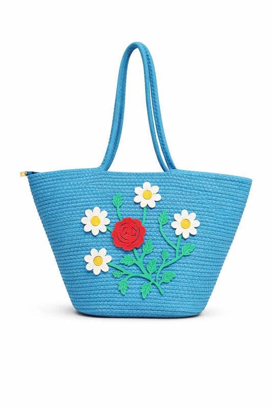 jutepie blue woven tote bag with floral embroidery featuring a red rose and white daisies on a white background